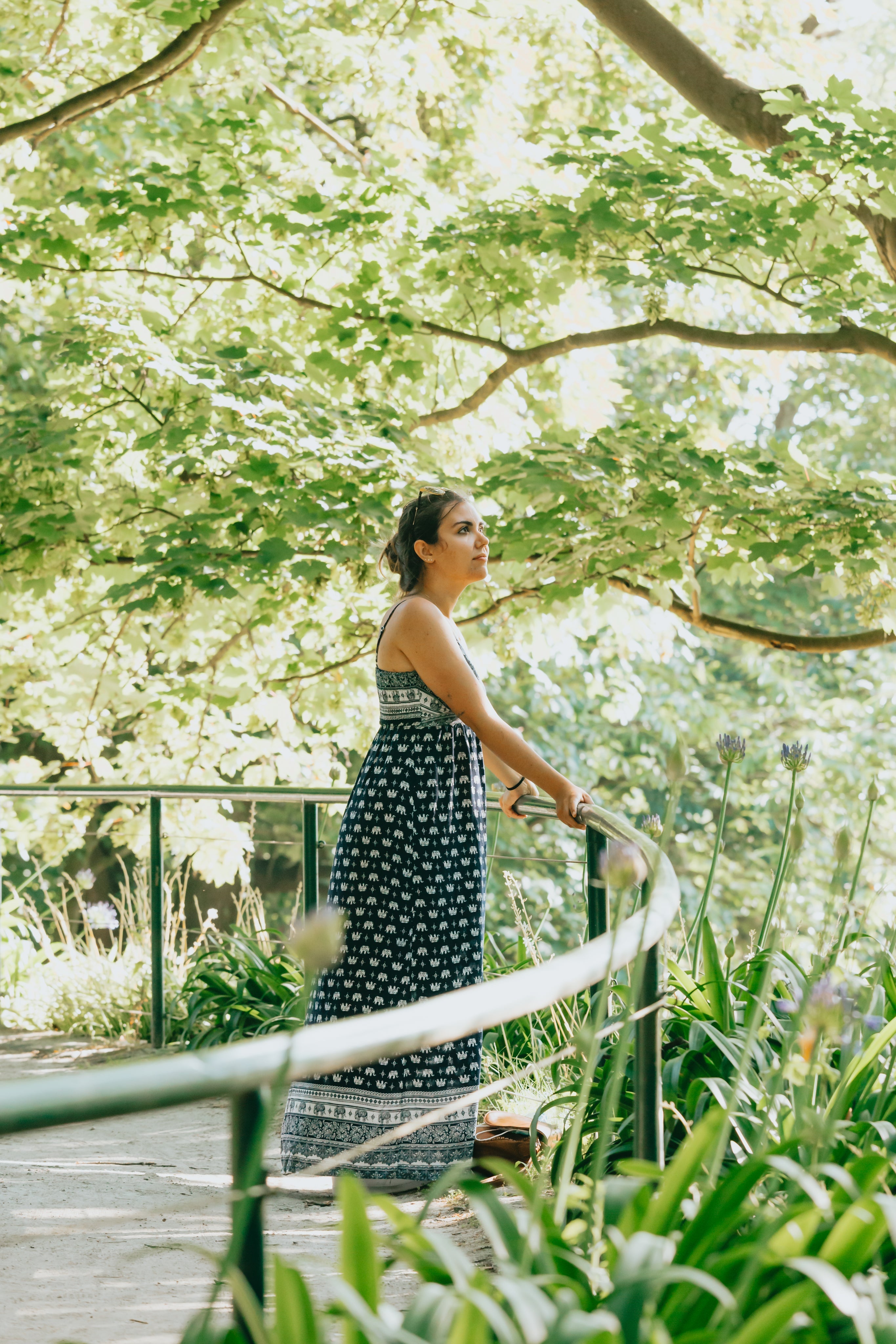 files/woman-in-blue-and-white-sundress-under-green-trees.jpg